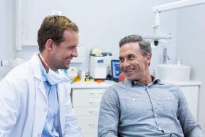 Dentist And Patient Interacting With Each Other